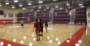 Volleyball game in gymnasium