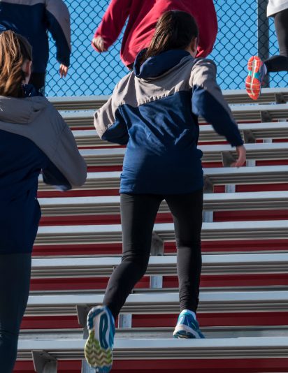 People running up stadium benches