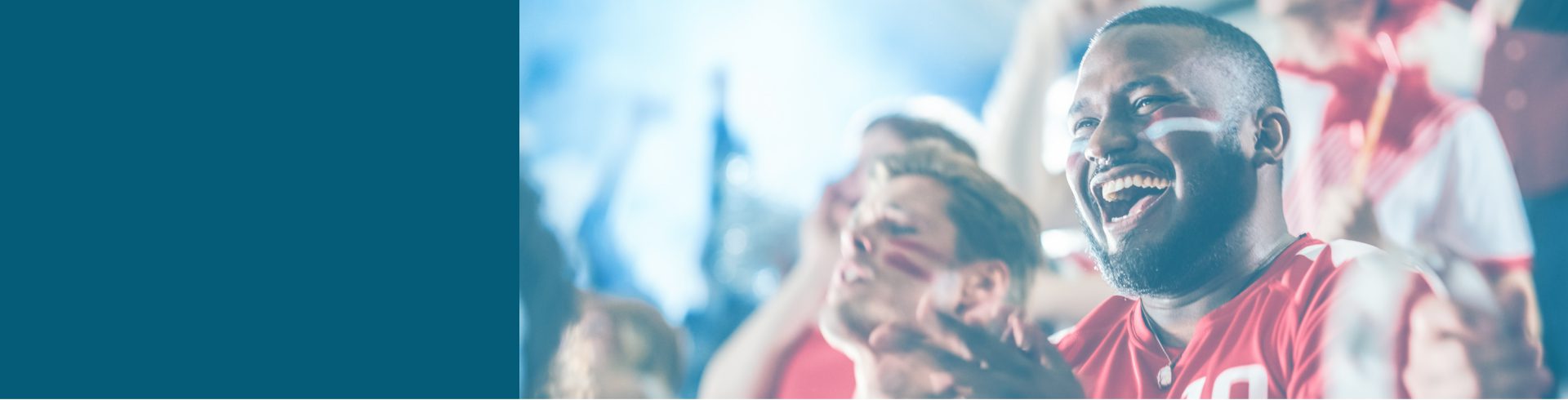 Man cheering sports team while sitting on bleachers